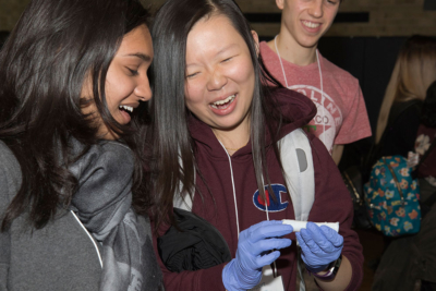 High school students examine a decellularized trachea during a lunch-and-learn session.